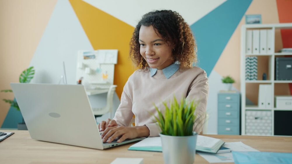 Therapist sits in a modern, sunlit St. Louis office, working on a laptop to improve their practice's online visibility for...