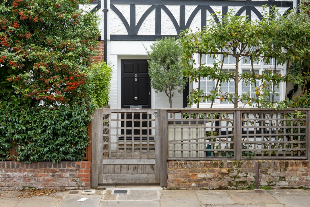 Welcoming front porch of a charming home with a brightly colored door and vibrant flowers in planters, showcasing excellen...